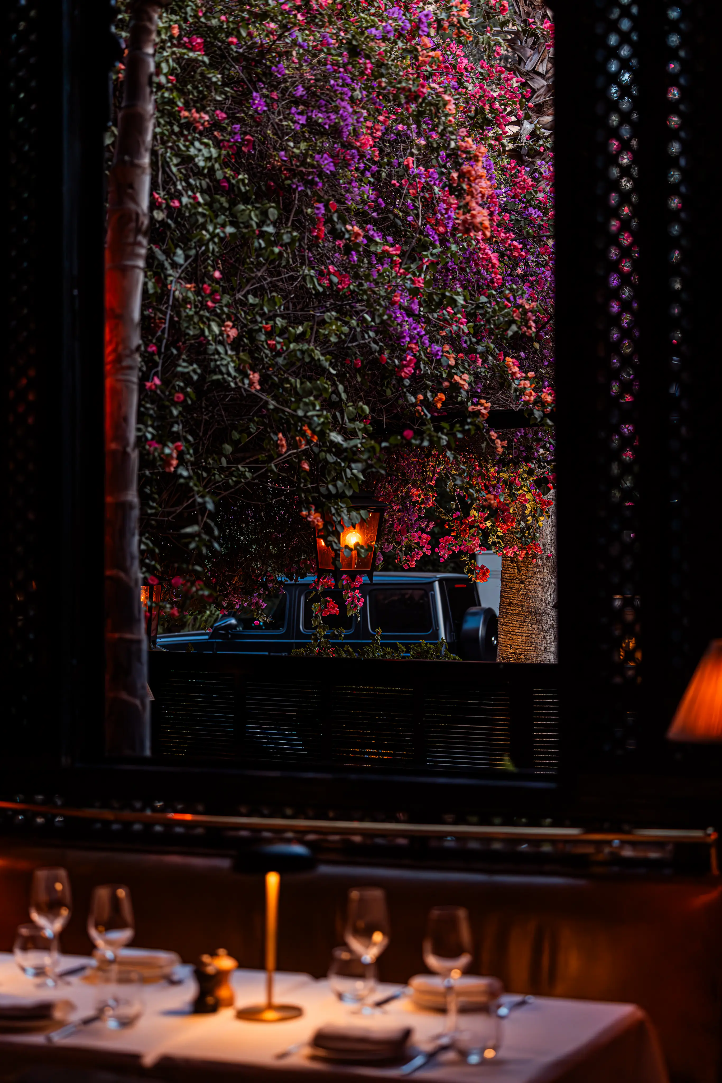 A romantic candlelit dinner setup inside an intimate, luxury fine dining restaurant in Marrakech.